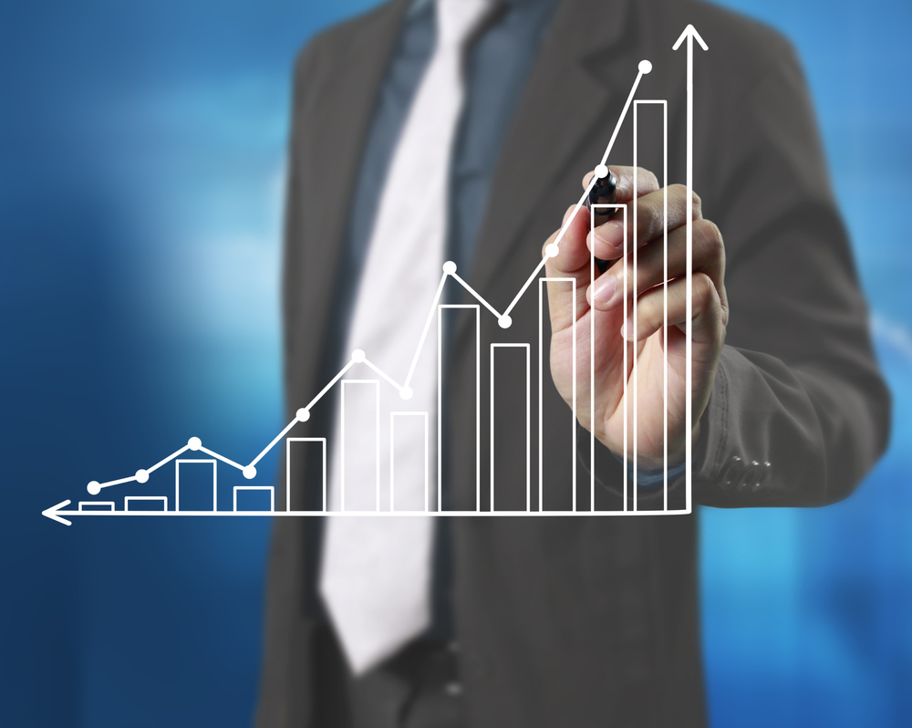 Businessman drawing graphics growing graph